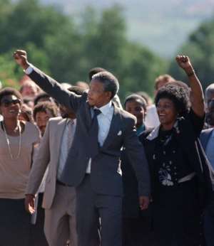 Mandela (C) and his then-wife Winnie raised their fists and saluted the cheering crowd. By Alexander JOE (FILES/AFP/File)