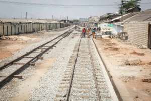 Maintenance staff walk along the renovated Accra-Tema line. Squatters had begun to encroach on the track during its closure. By RUTH MCDOWALL (AFP)