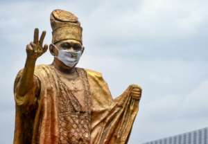 Mask message: A giant statue in Lagos of former Nigerian businessman and politician Moshood Abiola. By PIUS UTOMI EKPEI (AFP)