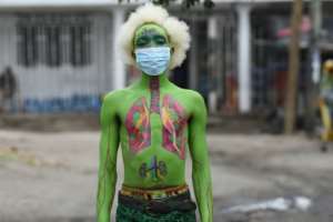 Masked: Performance artist Alex Kalemera tries to raise public awareness about the threat of coronavirus. By Ericky BONIPHACE (AFP)