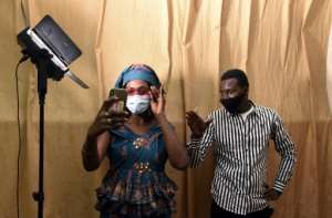 Masked rehearsals: Director Moustapha Kante and actress Aminata Diouf, who plays the role of Aby. By Seyllou (AFP)