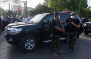 Members of the Tunisian military prevent parliament speaker Rached Ghannouchi's motorcade from entering the parliament on Monday. By FETHI BELAID (AFP)