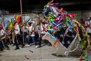 Members of the Afro-Mexican community perform the Dance of the Straw Bull. By PEDRO PARDO (AFP)