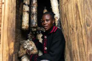 Memory Ruvinga and the mushrooms she grows as an additional source of income -- a scheme introduced by the Danish charity DCA. By Jekesai NJIKIZANA (AFP)