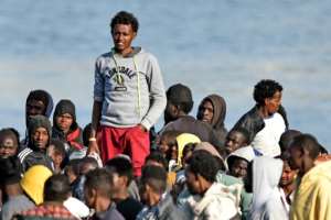 Men wait to disembark from the Italian Coast Guard vessel