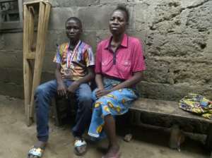 Mechanic Jamiu Ninilowo, 14, (L), joined the chess club in February and is now its best player. By PIUS UTOMI EKPEI (AFP)