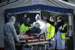 Medical personnel tended to patients at the reception of the Emergency Room, set up in a tent, in the suburbs of Paris. By Philippe LOPEZ (AFP)