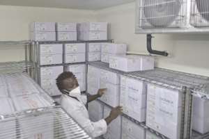 Medical personnel at the Nairobi National Vaccine Depot, where the country's first batch of COVID-19 vaccines are preserved in cold storage. By TONY KARUMBA (AFP)