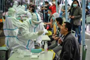 Medical workers conduct mass COVID-19 tests in Wuhan in China's central Hubei province. By STR (AFP)