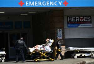 Medical workers transport a patient outside a special COVID-19 area at Maimonides Medical Center in New York City. By Johannes EISELE (AFP)