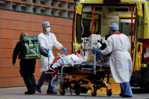 Medics take a patient from an ambulance into the Royal London hospital in London on January 19, 2021. By Tolga Akmen (AFP)