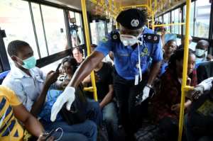 Mind the gap: Lagos Police Commissioner Hakeem Odumosu, pictured in March, as he urges social distancing on a city bus. Public transport, streets and markets are notoriously crowded, making it hard for Lagosians to keep their distance. By PIUS UTOMI EKPEI (AFP)