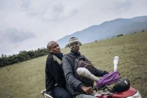 Minembwe's mayor Gadi Muzika, left, rides back to town after the funeral. By ALEXIS HUGUET (AFP)
