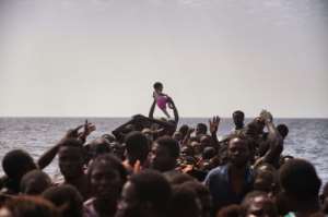 Migrants wait to be rescued by the Proactiva Open Arms NGO in the Mediterranean Sea off the coast of Libya on October 4, 2016