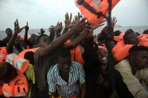 Migrants are rescued by members of the Proactiva Open Arms NGO in the Mediterranean Sea off the coast of Libya on October 4, 2016