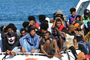 Migrants from Tunisia and Libya arrive onboard of an Italian Coast Guard boat on the Italian island of Lampedusa on August 1. By Alberto PIZZOLI (AFP/File)