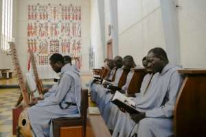 Monks at Keur Moussa sing accompanied by the kora instead of an organ. By CARMEN ABD ALI (AFP)