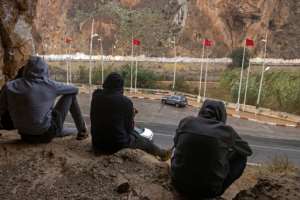 Moroccan youth sit across the border with Algeria, in the city of Oujda on November 3. By FADEL SENNA (AFP)