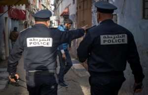 Moroccan policemen instruct people to return to and remain at home as a measure against the COVID-19 coronavirus pandemic in the capital Rabat's district of Takadoum. By FADEL SENNA (AFP)