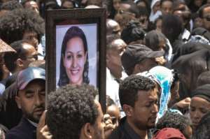 Mourners in Addis Ababa, Ethiopia carry portraits of victims from the Ethiopian Airlines crash. By Samuel HABTAB (AFP)