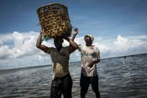 Mozambican fishermen return from fishing from an area where large deposits of natural gas are located