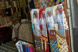 Mozambicans have been splurging on pope-related regalia. By GIANLUIGI GUERCIA (AFP/File)