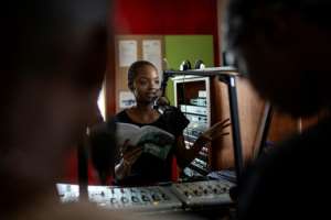 Mpho Molutsi at the microphone. By GULSHAN KHAN (AFP)