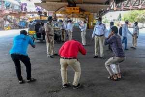 Mumbai police order people to do sit-ups as punishment for going out without a valid reason during a government-imposed nationwide lockdown in India. By INDRANIL MUKHERJEE (AFP)