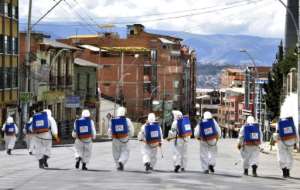Municipal workers disinfect the streets of La Paz, Bolivia, as a preventive measure to slow the spread of the novel coronavirus, COVID-19. By Aizar RALDES (AFP)