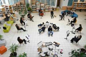 Musicians from the Victor Hugo orchestra play for high school students at the Germaine Tillon high school library in Montbeliard, France. By SEBASTIEN BOZON (AFP)