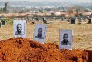 Nyanya Yawa, Katyana Zoya and Mpitizeli Zoya, both dumb, share a grave in Mamelodi West Cemetery, where executed black prisoners were buried under apartheid. By Phill Magakoe (AFP / File)