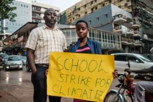 Namugerwa, seen with her father and agent Lukwago Cephas, says some people have criticised her, telling her she should be at school rather than striking -- but her parents have encouraged her. By SUMY SADURNI (AFP/File)