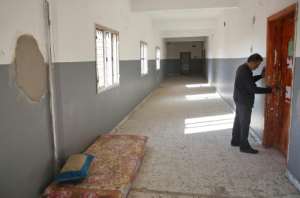 Newly administered plaster fills a gaping hole left by the fighting, which saw the school peppered with shells and gunfire. By Mahmud TURKIA (AFP)