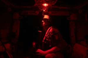Night watch: A sergeant stands guard inside an armoured personnel carrier. By MICHELE CATTANI (AFP)