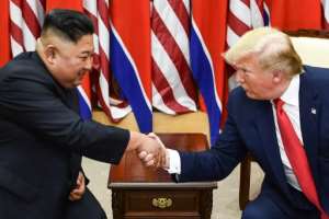 North Korea's leader Kim Jong Un (L) and US President Donald Trump shake hands at a meeting south of the Military Demarcation Line that divides North and South Korea in June 2019 -- their summits have been historic, if not full of concrete results. By Brendan Smialowski (AFP/File)