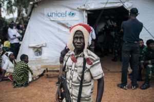'Not choirboys': A militiaman stands guard during talks with ex-warlords in the village of Wadda. By ALEXIS HUGUET (AFP)