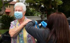 Nurse Liliana Ocampo administers the Moderna Covid-19 vaccine into the arm of Sister Pat Foster in Los Angeles. By Frederic J. BROWN (AFP)