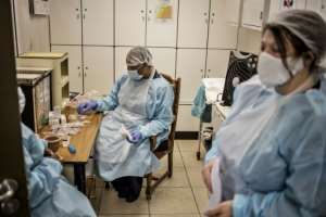 Nurses keep a close eye on residents -- spotting early symptoms is crucial for preventing contagion. By MARCO LONGARI (AFP)