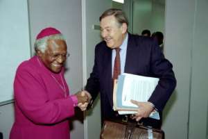 October 14, 1997: South Africa's then foreign minister, Pik Botha, shakes hands with Tutu as he arrives at the Truth and Reconciliation Commision. By Odd ANDERSEN (AFP)