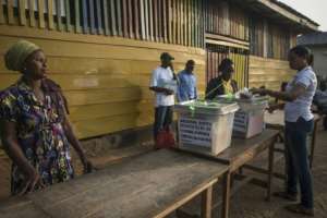 Officials prepare ballots and boxes for the presidential election at a polling station in Kibi, southern Ghana, on December 7, 2016