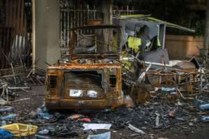 On a main road into town, businesses have been looted and burnt black, their front windows shattered, their walkways covered in twisted scrap metal. By - (AFP)