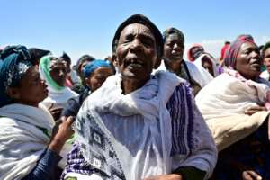 Oromo women perform a traditional chant at the crash site at Hama Quntushele village, in Oromia region. By TONY KARUMBA (AFP)