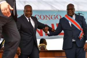 Outgoing President Joseph Kabila, left, at Tshisekedi's inauguration in January 2019. By TONY KARUMBA (AFP / Archive)