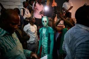 Painted protest: A Cisse supporter attends a rally to condemn alleged vote rigging. By Michele CATTANI (AFP)