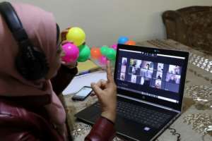 Palestinian teacher Jihad Abu Sharar conducts an online class from her home in the occupied West Bank. By Hazem BADER (AFP)