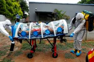 Paramedics take a man showing symptoms of COVID-19 to hospital near Pretoria in South Africa. A new strain of the virus that emerged in the country is already spreading around the world. By Phill Magakoe (AFP/File)