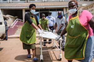 Paramedics tended to dozens of victims at Kampala's Mulago National Referral Hospital. By Sumy SADRUNI (AFP)