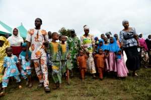 Parents lead children at a parade of twins at the Igbo-Ora festival. The one-day event draws families from across Nigeria. By PIUS UTOMI EKPEI (AFP)