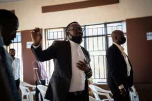 Pastor Jean de Dieu Uwiragiye (C) has long been an ally of Rwanda's LGBTQ community.  By Simon WOHLFAHRT (AFP)