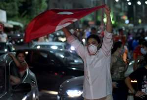 People celebrate in the streets of Tunis after Tunisian President Kais Saied announced the suspension of parliament and the dismissal of the prime minister. By FETHI BELAID (AFP)